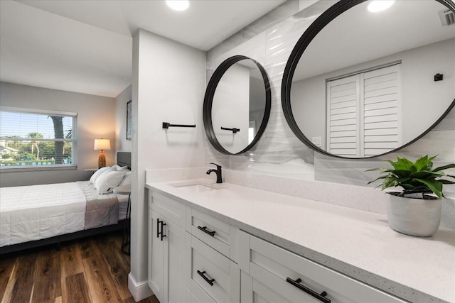 ensuite bathroom with wood finished floors, vanity, and ensuite bathroom