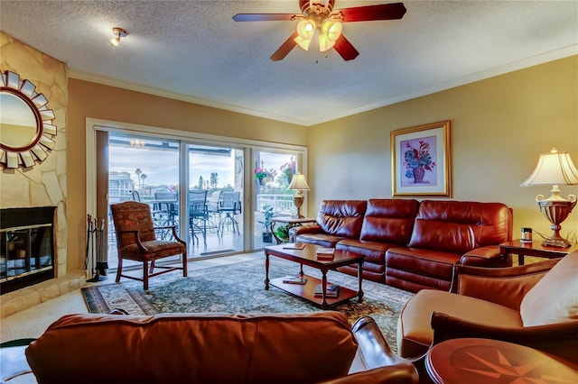 carpeted living room with crown molding, a fireplace, a textured ceiling, and ceiling fan