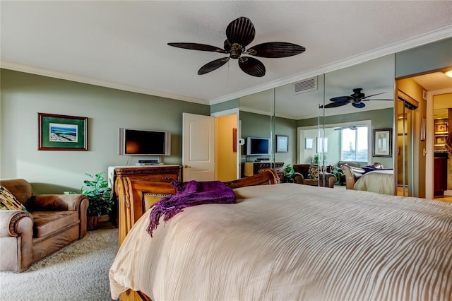 bedroom with carpet floors, a ceiling fan, visible vents, and crown molding