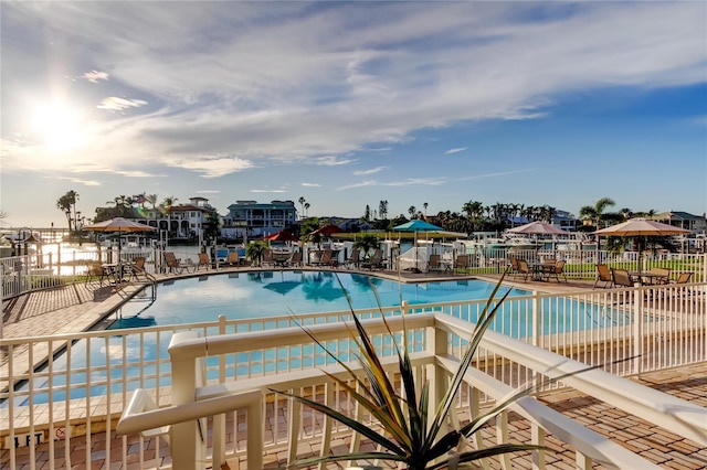 community pool featuring a patio and fence