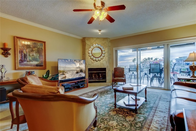 living area with a textured ceiling, a premium fireplace, a ceiling fan, and crown molding