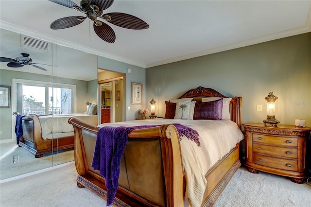 bedroom featuring crown molding, a ceiling fan, visible vents, and light colored carpet