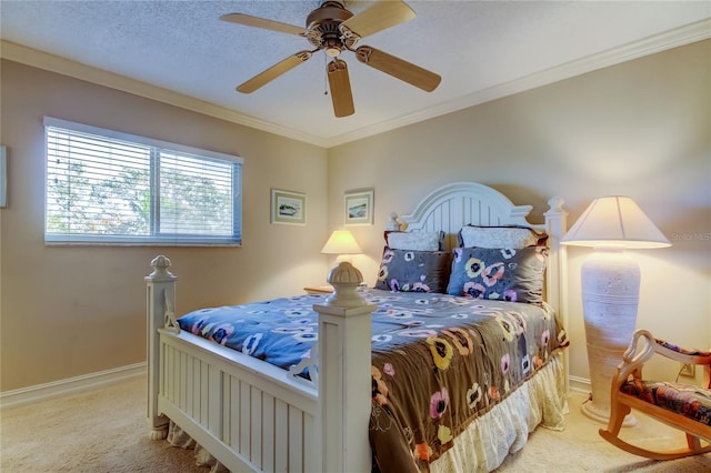 carpeted bedroom with a ceiling fan, a textured ceiling, baseboards, and crown molding