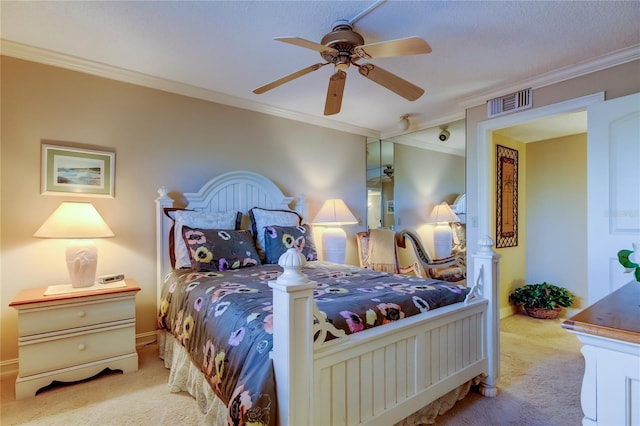 carpeted bedroom featuring ceiling fan, visible vents, baseboards, and ornamental molding