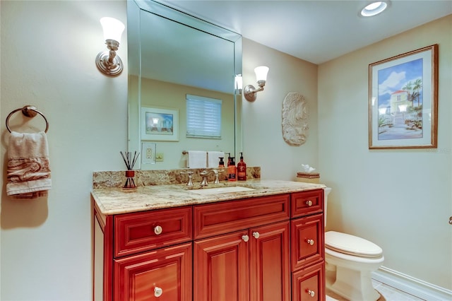 bathroom featuring toilet and vanity