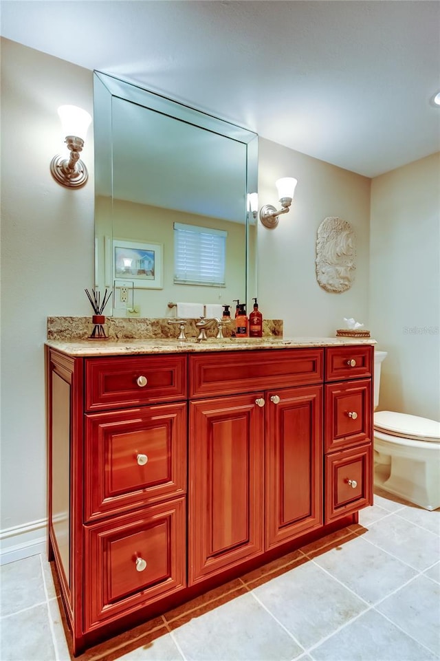 bathroom featuring tile patterned flooring, vanity, and toilet