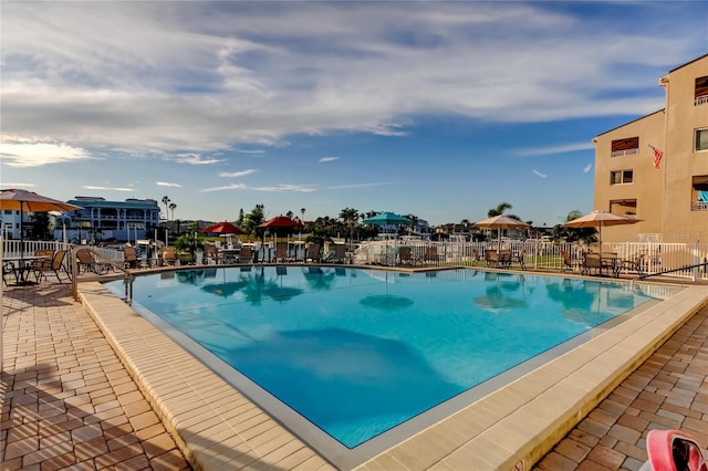 view of pool with a patio area and fence