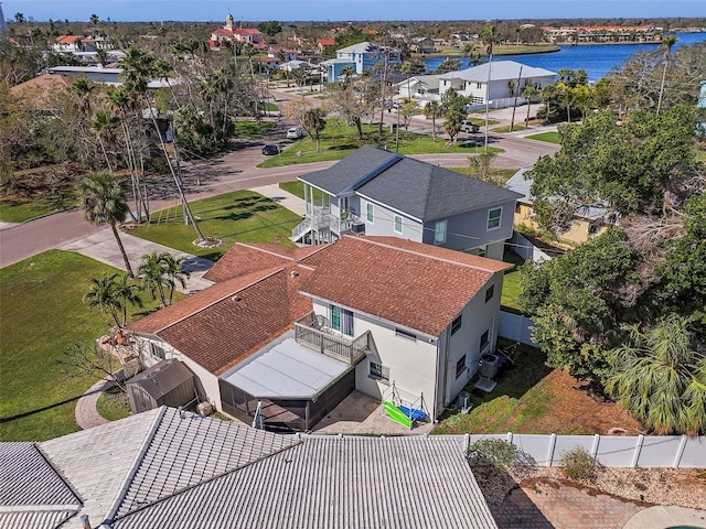 drone / aerial view with a water view and a residential view