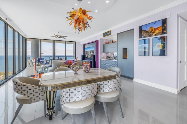 dining space with expansive windows, a water view, crown molding, and baseboards