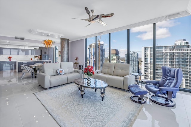 tiled living area featuring expansive windows, ceiling fan, visible vents, and a city view