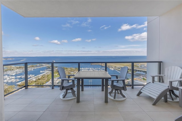 balcony with a water view and a view of the beach