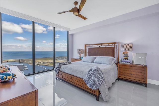 bedroom with a water view, expansive windows, and light tile patterned flooring