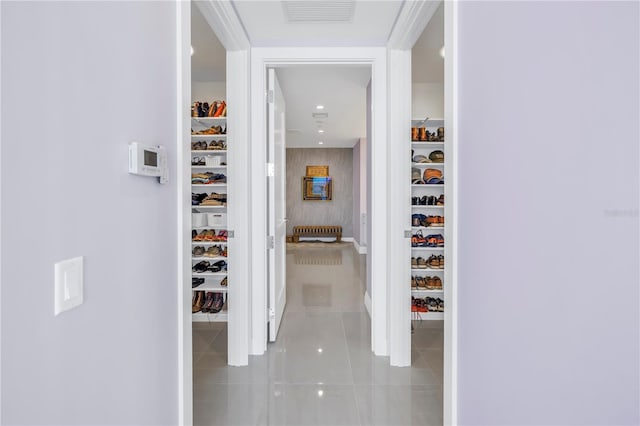 hall featuring light tile patterned floors and visible vents