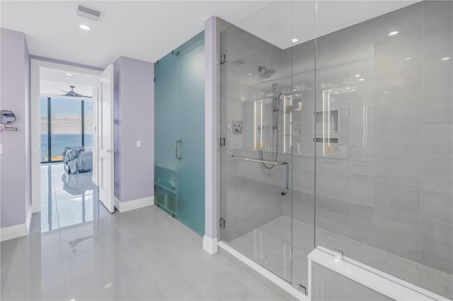 ensuite bathroom with visible vents, a stall shower, ceiling fan, ensuite bath, and baseboards