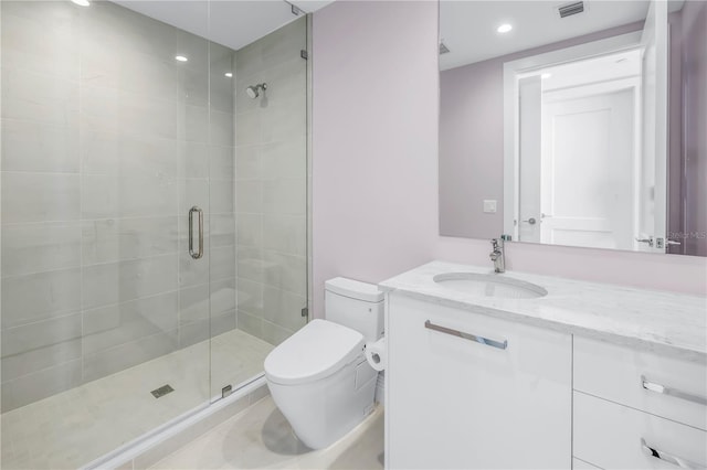 bathroom with visible vents, toilet, vanity, a shower stall, and recessed lighting