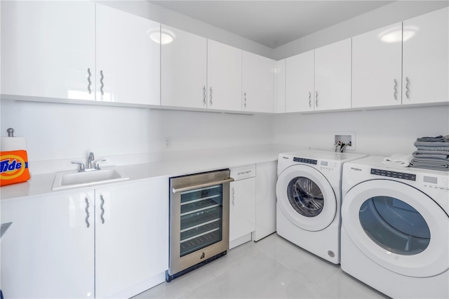 laundry room with separate washer and dryer, wine cooler, a sink, and cabinet space