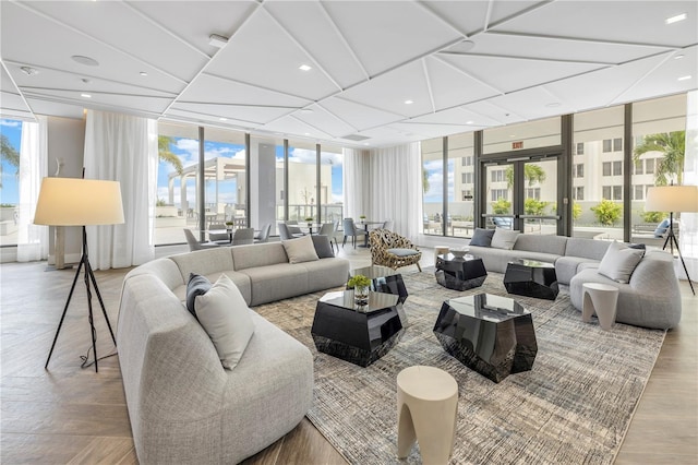 living room with french doors, a wall of windows, recessed lighting, and light wood-style floors