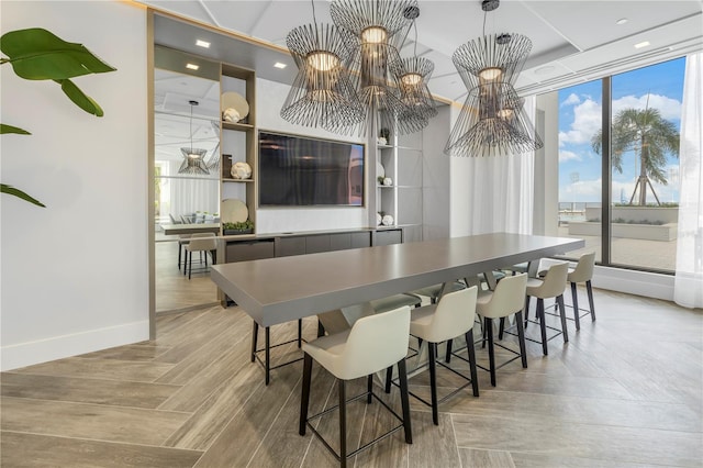 dining room featuring recessed lighting, an inviting chandelier, light wood-style flooring, and baseboards