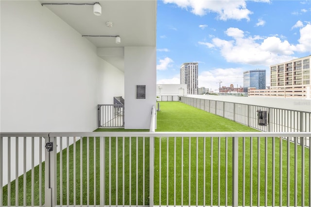 view of yard featuring a view of city and fence