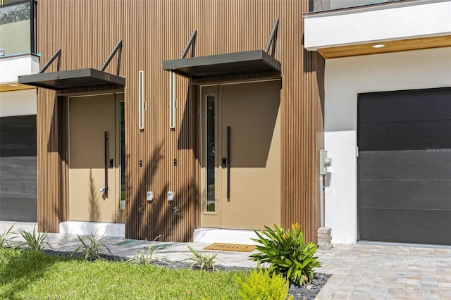 exterior space with a garage and stucco siding