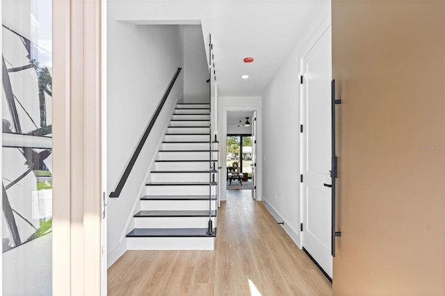 foyer featuring recessed lighting, baseboards, stairway, and light wood finished floors