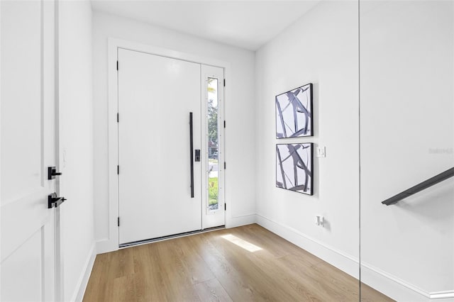 foyer entrance featuring light wood-type flooring and baseboards