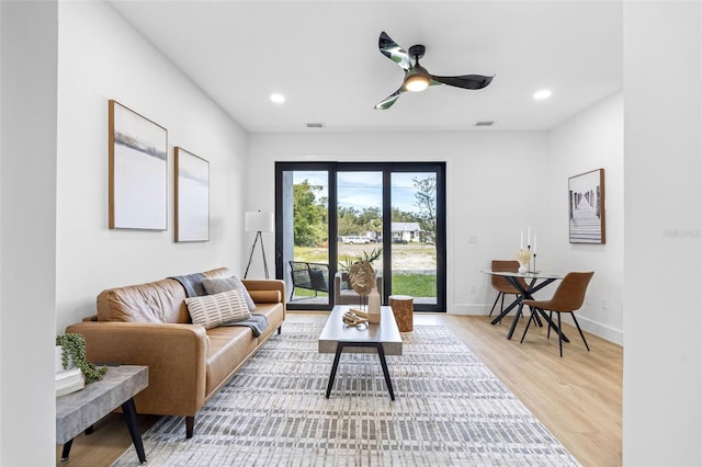 living area featuring ceiling fan, baseboards, wood finished floors, and recessed lighting