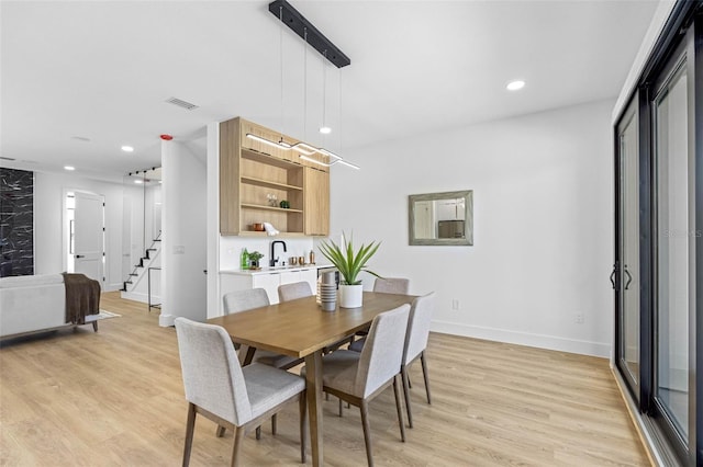 dining space featuring recessed lighting, visible vents, baseboards, stairs, and light wood-style floors