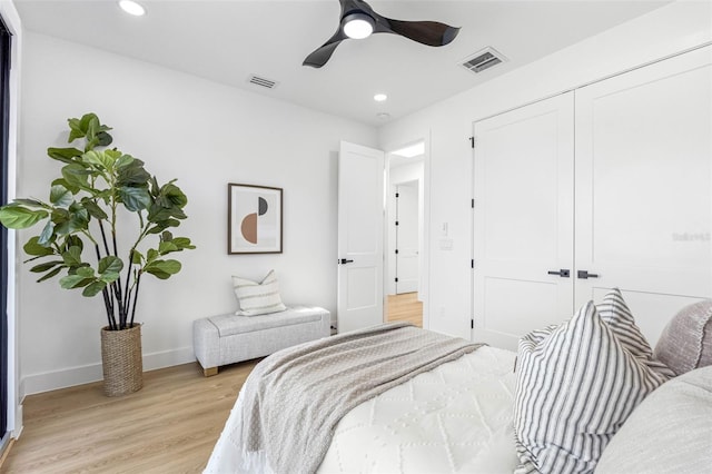 bedroom with recessed lighting, visible vents, baseboards, a closet, and light wood finished floors