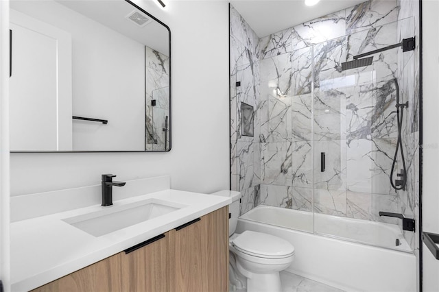 bathroom featuring marble finish floor, visible vents, toilet, combined bath / shower with glass door, and vanity