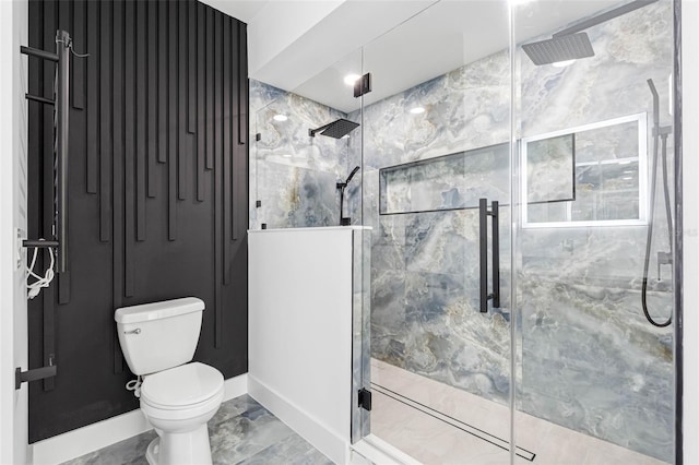 full bathroom featuring marble finish floor, a shower stall, and toilet