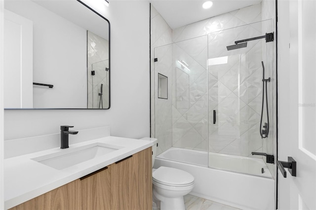 full bath featuring marble finish floor, vanity, toilet, and bath / shower combo with glass door