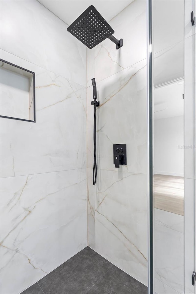 full bathroom with a marble finish shower