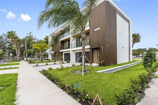 view of building exterior featuring driveway and an attached garage