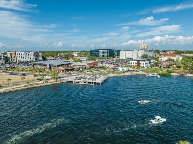 birds eye view of property with a water view and a city view