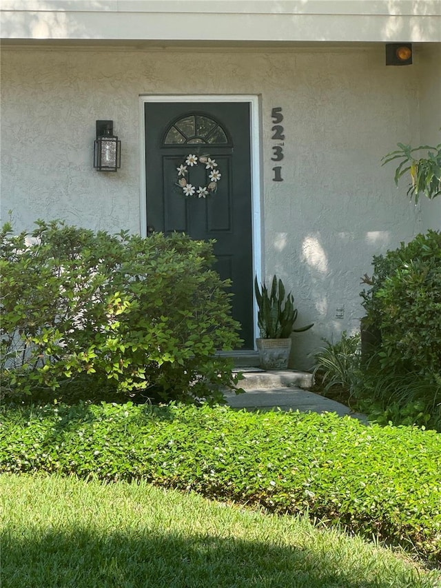 entrance to property with stucco siding