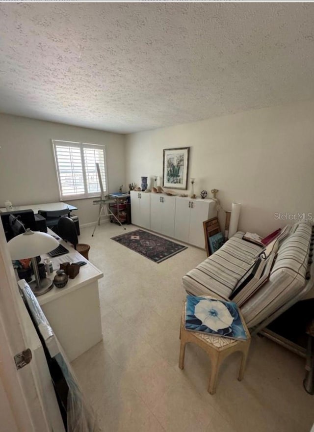 interior space featuring a textured ceiling and light floors