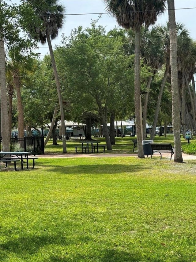 view of home's community featuring a yard and fence