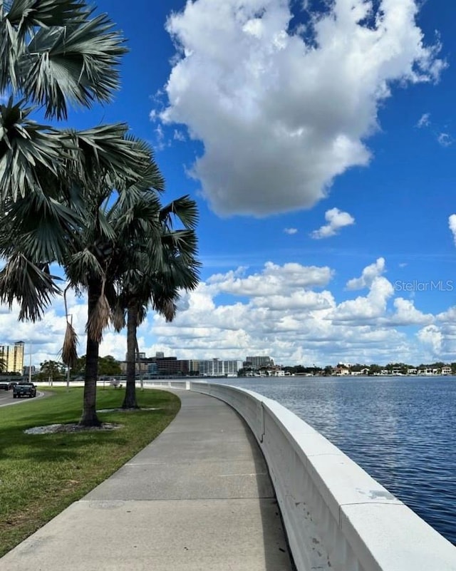 exterior space featuring a lawn and a water view