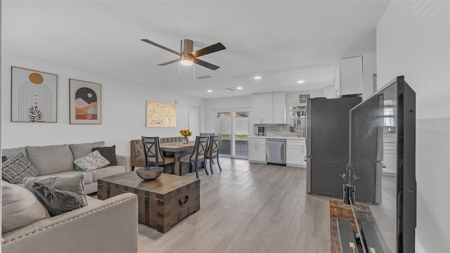 living area featuring ceiling fan, light wood-style flooring, and recessed lighting