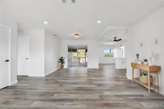 unfurnished living room featuring recessed lighting, baseboards, and wood finished floors