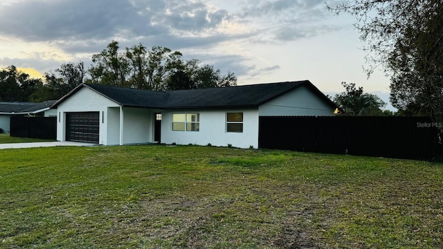 exterior space featuring a garage, concrete driveway, and a front yard