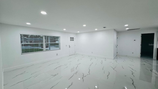 empty room featuring recessed lighting, marble finish floor, visible vents, and baseboards