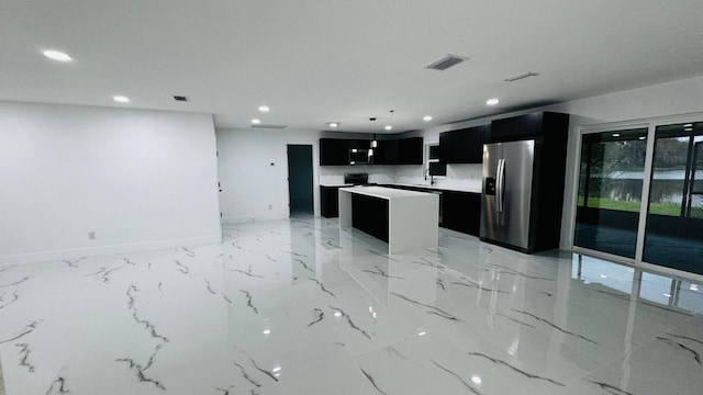 kitchen with recessed lighting, visible vents, appliances with stainless steel finishes, a kitchen island, and dark cabinets
