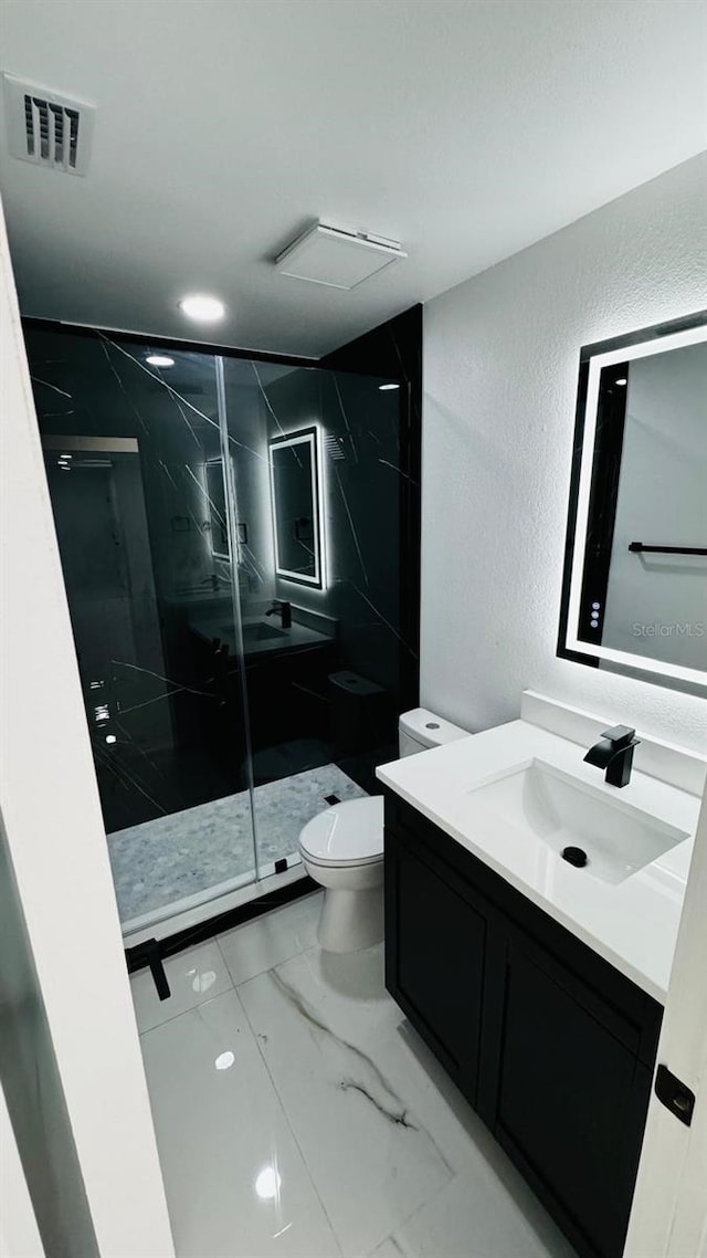 full bathroom with marble finish floor, a marble finish shower, visible vents, toilet, and vanity