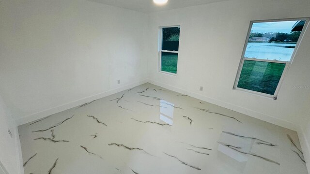 spare room with baseboards