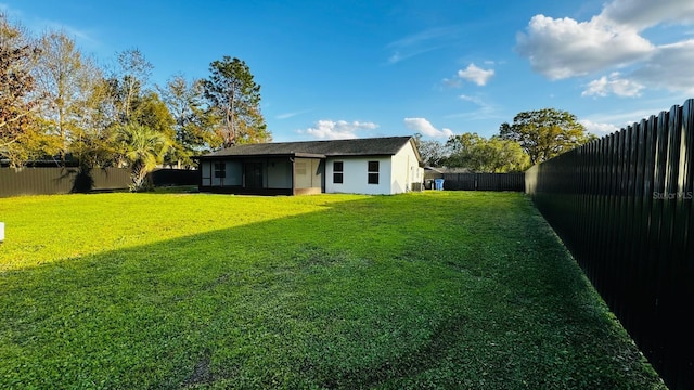 view of yard with a fenced backyard