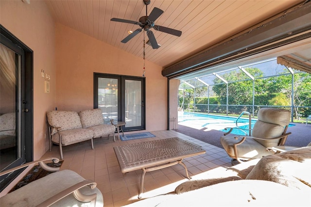 view of patio / terrace with ceiling fan, glass enclosure, outdoor lounge area, and an outdoor pool