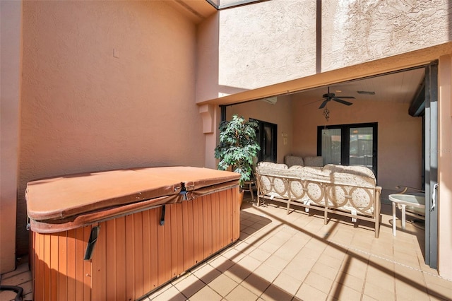 view of patio / terrace featuring ceiling fan and a hot tub