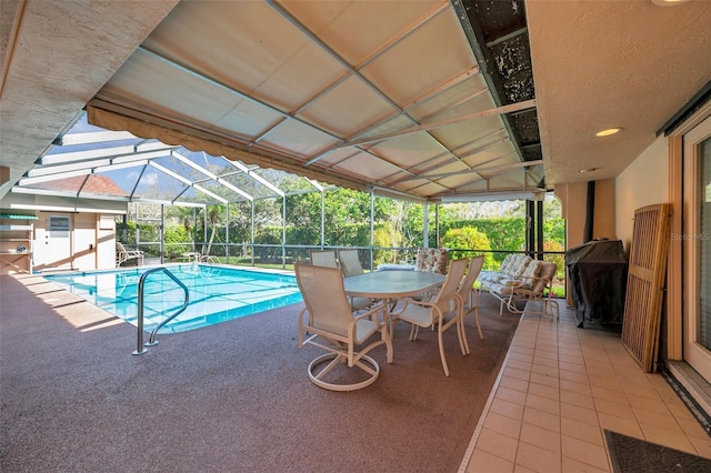 pool featuring a lanai, a patio area, and grilling area